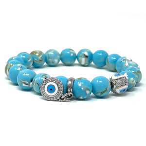 Turquoise beaded bracelet with evil eye charms on a white background